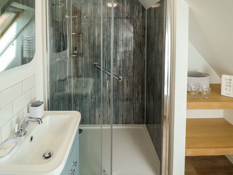 A bathroom with a shower and sink at Bobblehat Barn in Alford