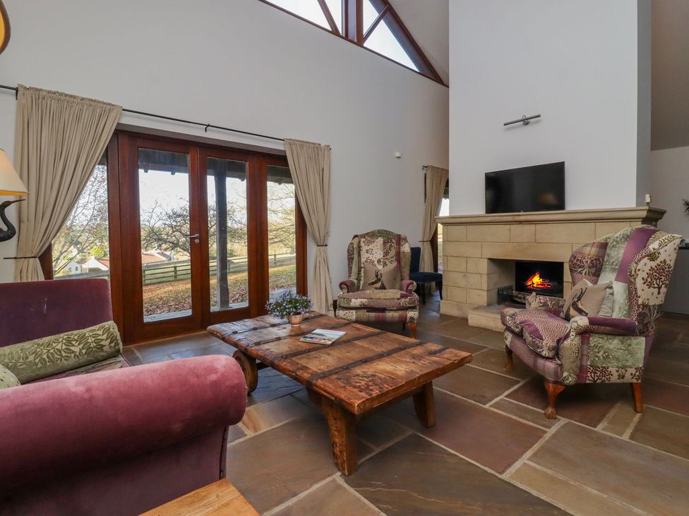 A living room with armchairs and a coffee table at Sandy Gate in Knaresborough