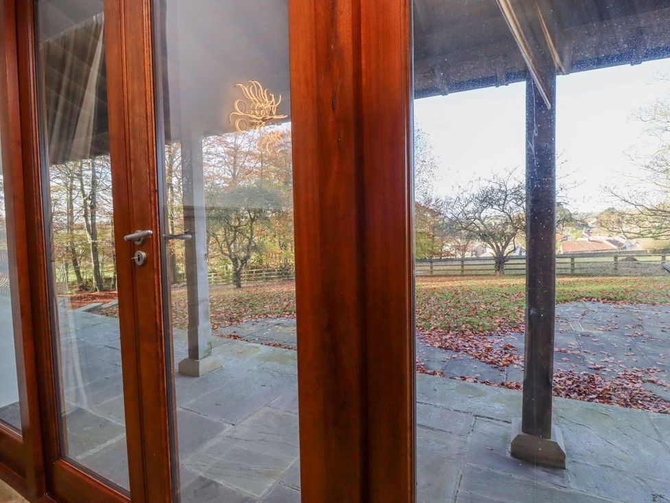 Glass doors opening to a patio area at Sandy Gate in Knaresborough