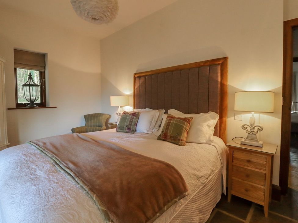 A bedroom with a bed and bedside table at Sandy Gate in Knaresborough
