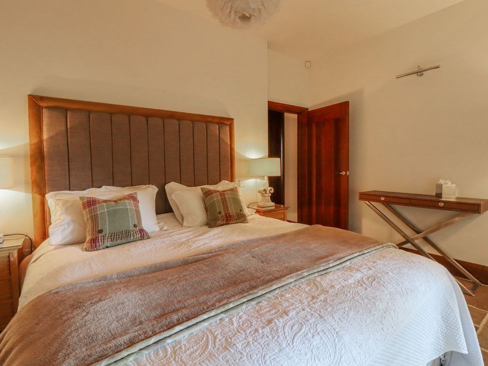 A bedroom with a bed and bedside table at Sandy Gate in Knaresborough