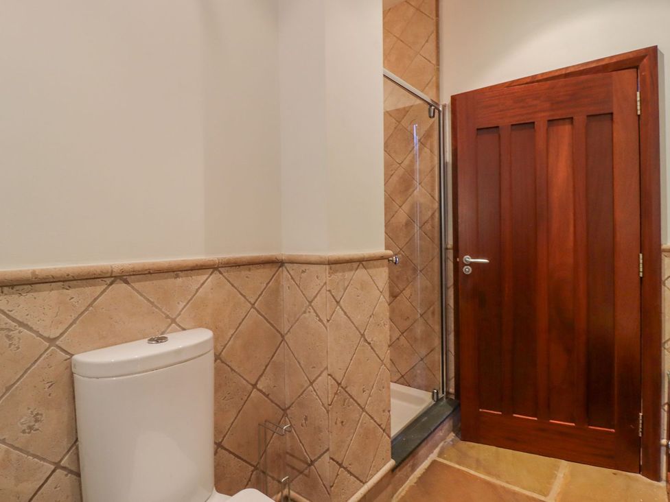 A bathroom with a toilet and shower at Sandy Gate in Knaresborough
