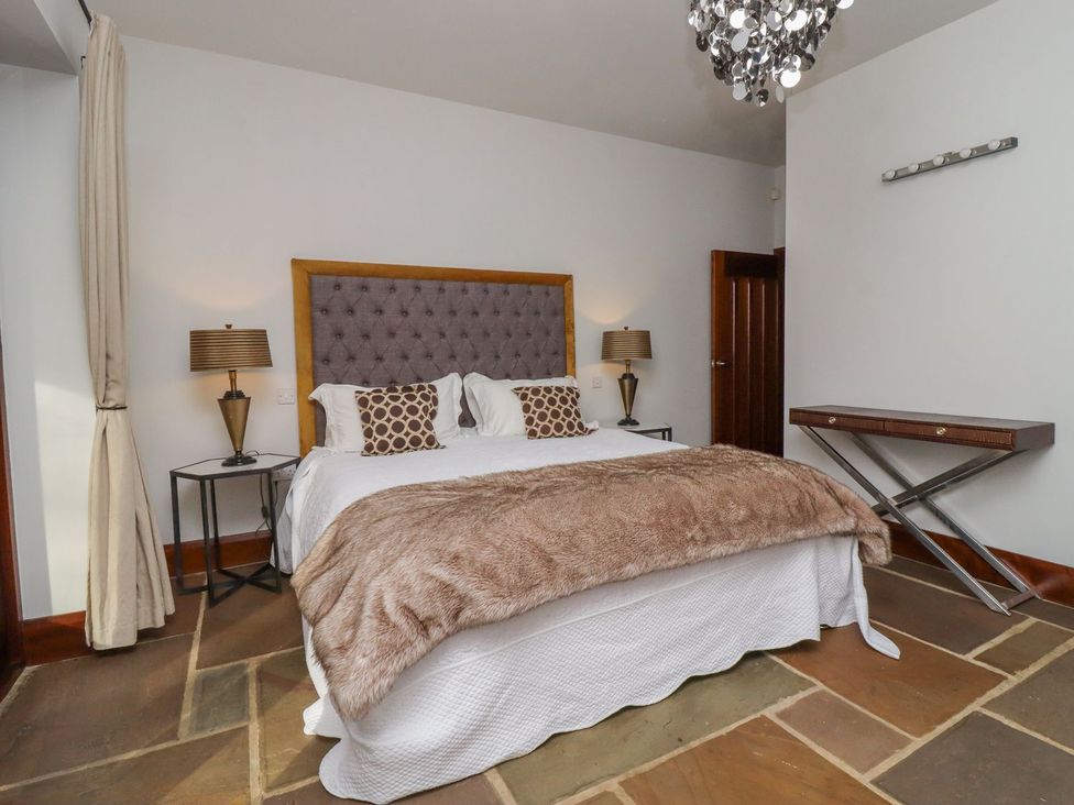 A bedroom with a bed and nightstands at Sandy Gate in Knaresborough