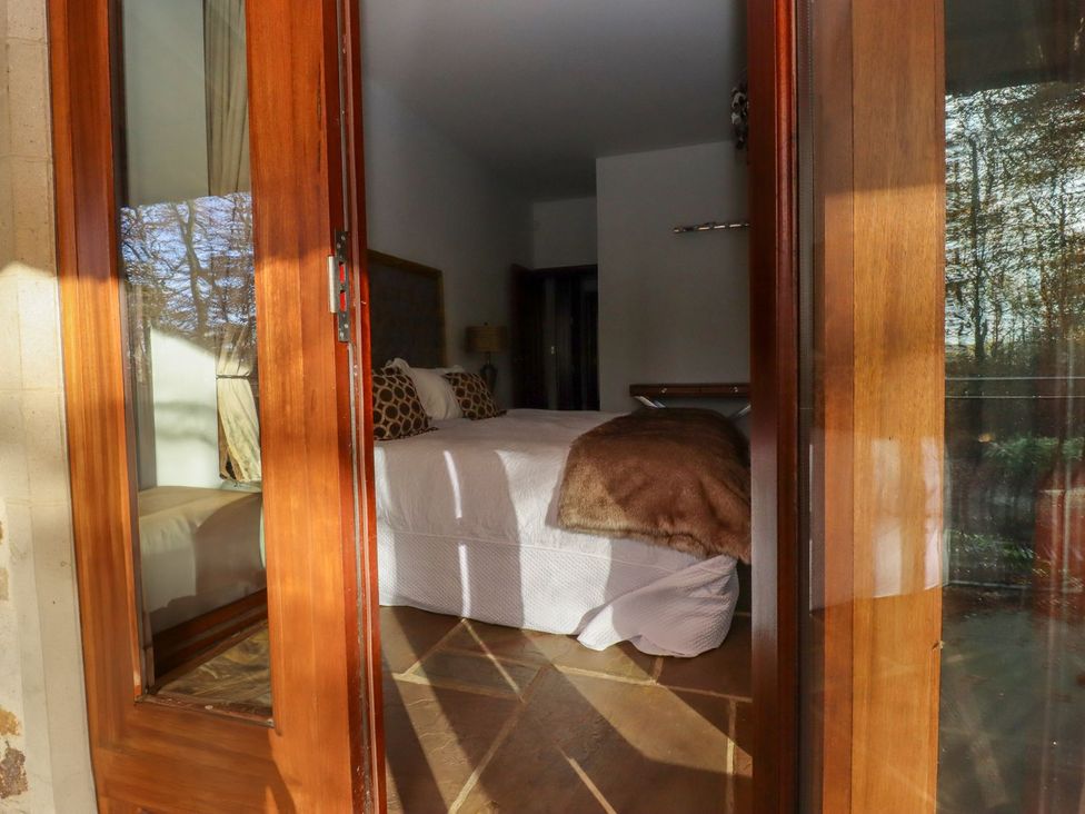 A bedroom with a bed and window at Sandy Gate in Knaresborough