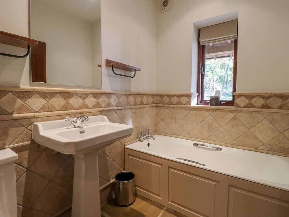 A bathroom with a sink and bathtub at Sandy Gate in Knaresborough