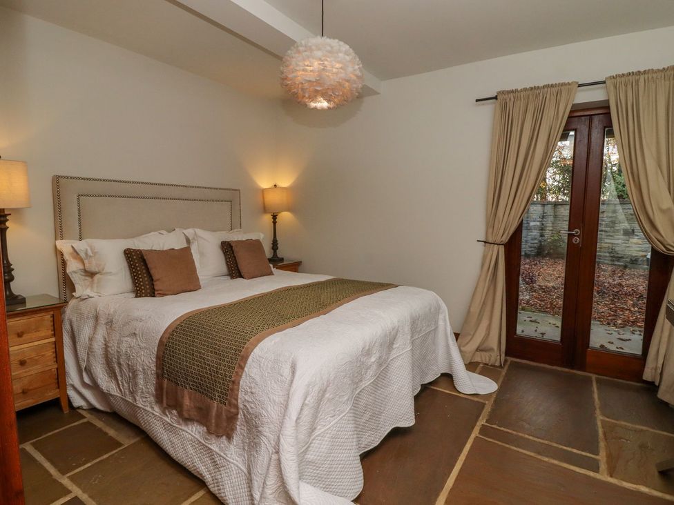 A bedroom with a bed and nightstand at Sandy Gate in Knaresborough
