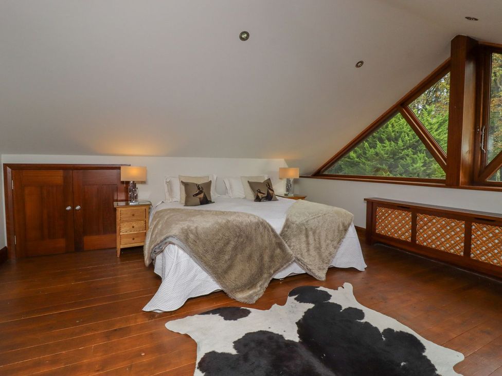 A bedroom with a bed and dresser at Sandy Gate in Knaresborough