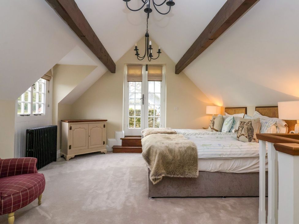 A bedroom with a bed and a chair at The Bothy in Knaresborough