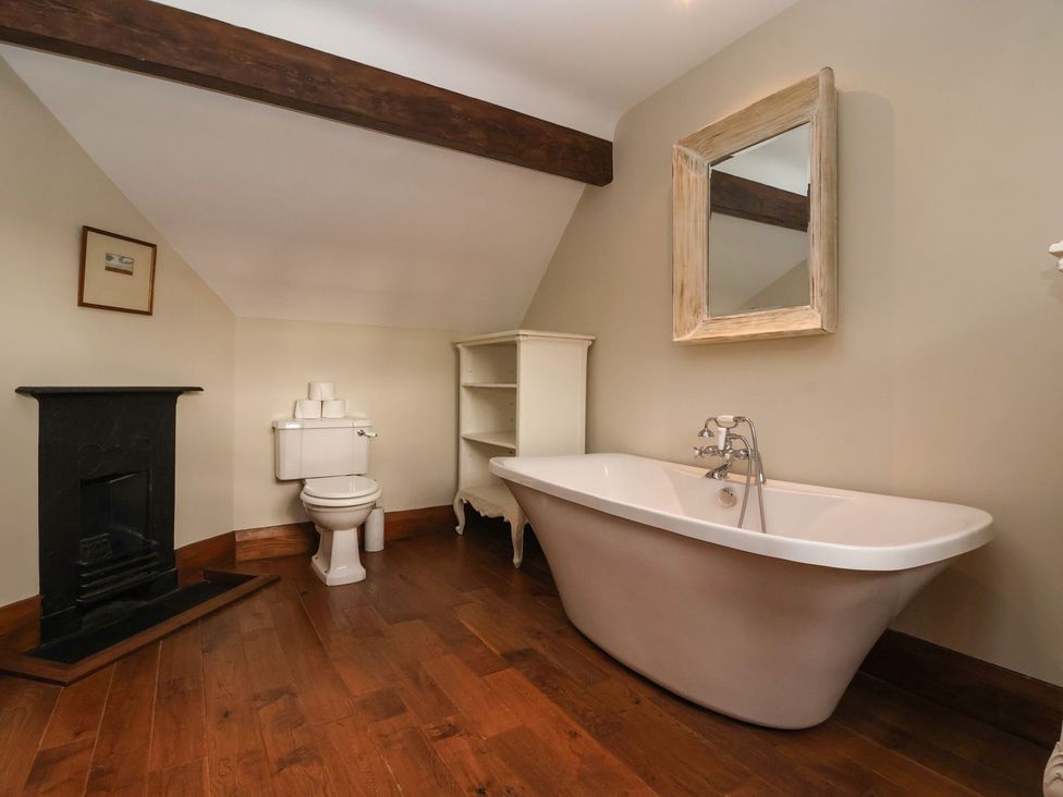 A bathroom with a bathtub and toilet at The Bothy in Knaresborough