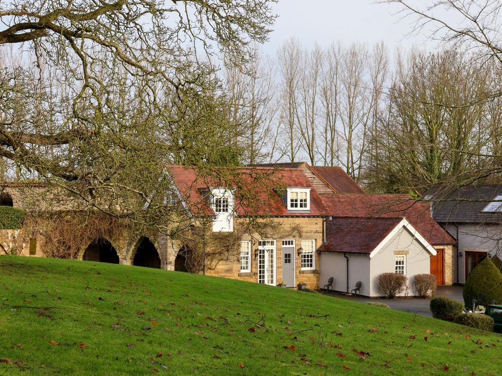A house with trees and grassy area at The Bothy in Knaresborough
