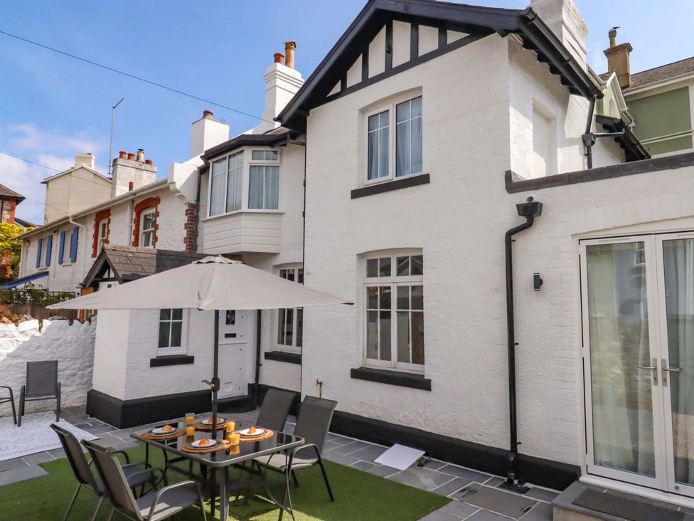 An outdoor dining area with table and chairs at Kents Cottage in Torquay