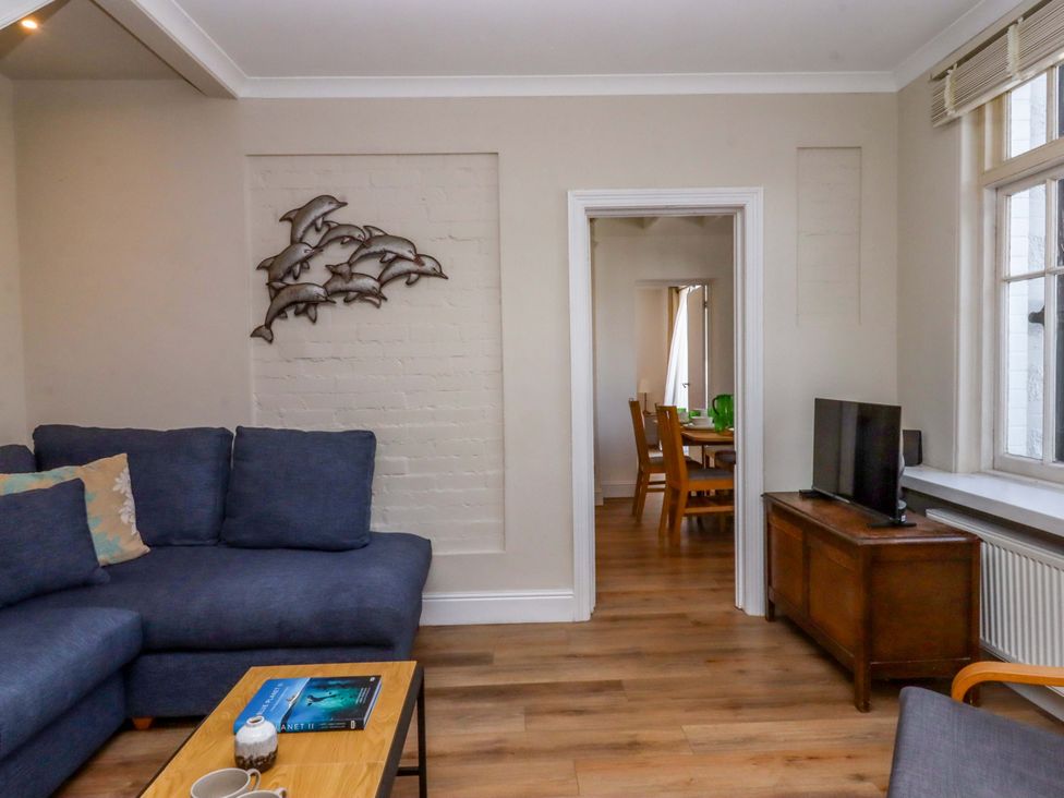 A living room with a sofa and coffee table at Kents Cottage in Torquay