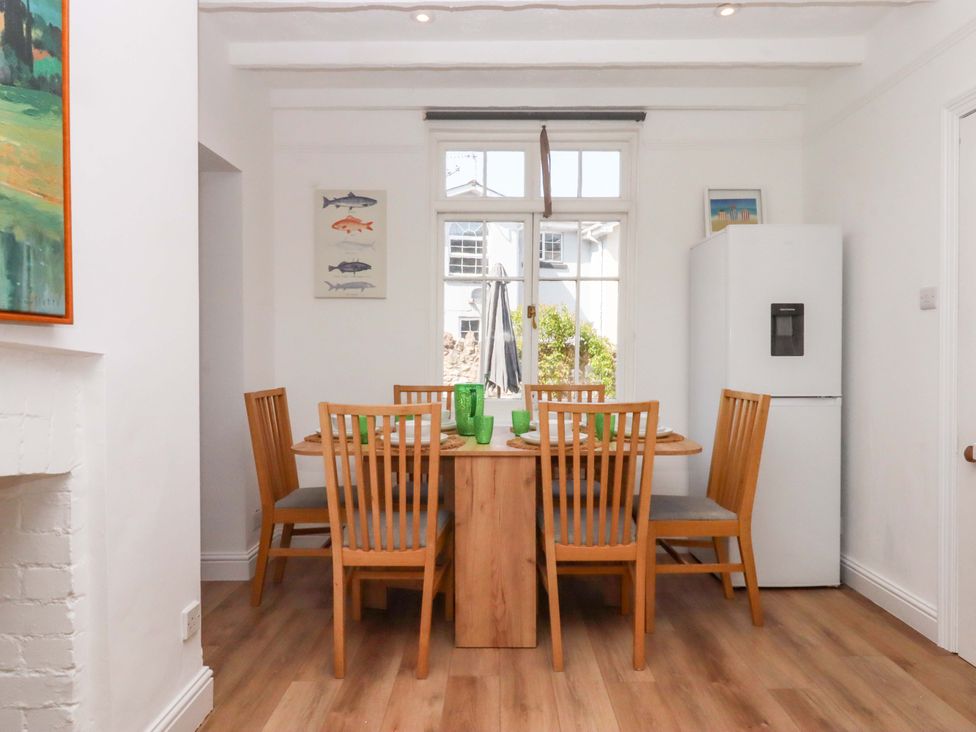 A dining room with a table and chairs at Kents Cottage in Torquay