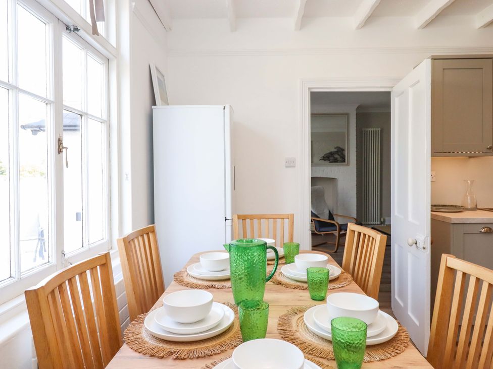 A dining room with table set for meal at Kents Cottage in Torquay