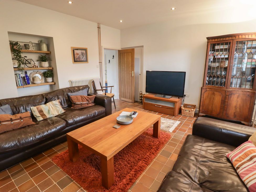 A living room with a sofa and coffee table at No.8 Millmoor Farm Cottage Broad Haven