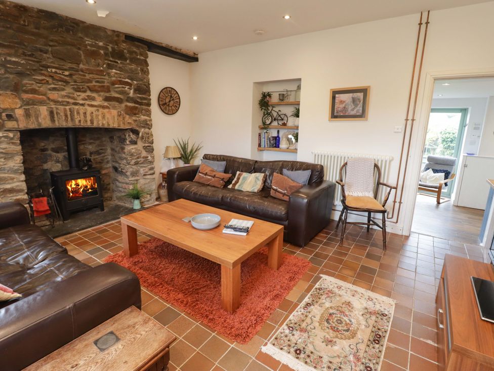 A living room with a fireplace and furniture at No.8 Millmoor Farm Cottage Broad Haven