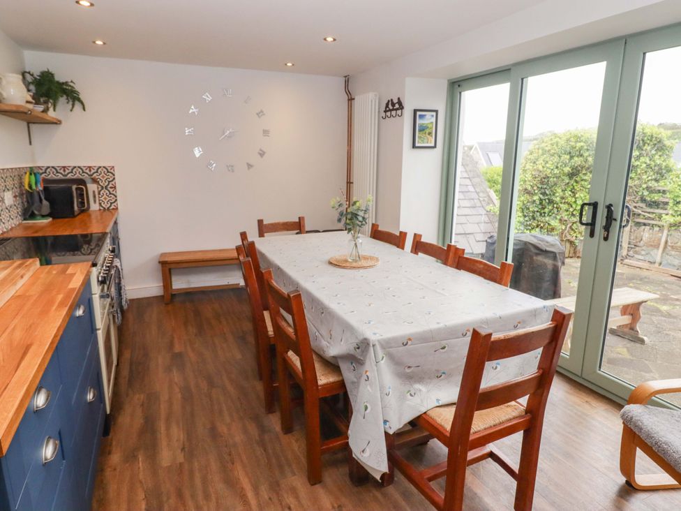 A dining room with a table and chairs at No.8 Millmoor Farm Cottage in Broad Haven