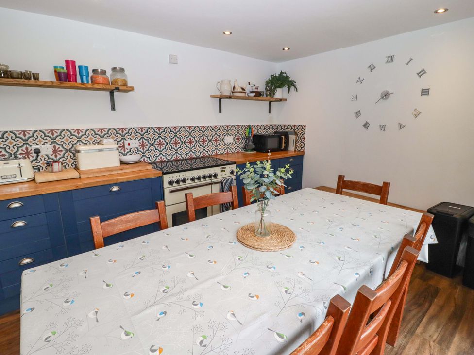 A kitchen with a table and chairs at No.8 Millmoor Farm Cottage in Broad Haven