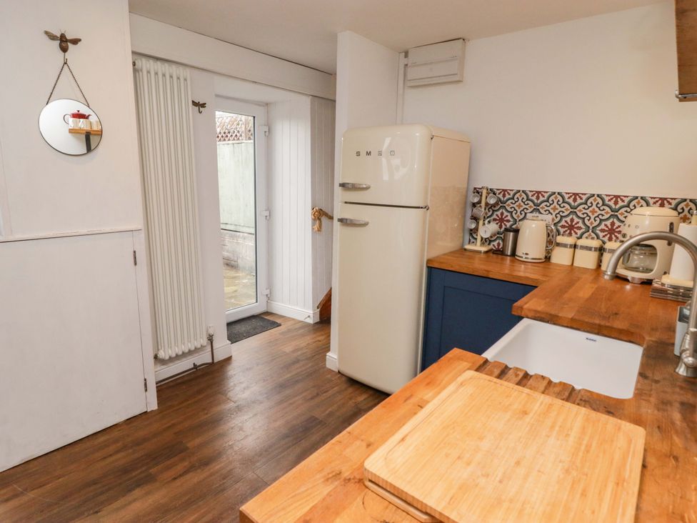 A kitchen with refrigerator and countertop at No.8 Millmoor Farm Cottage Broad Haven