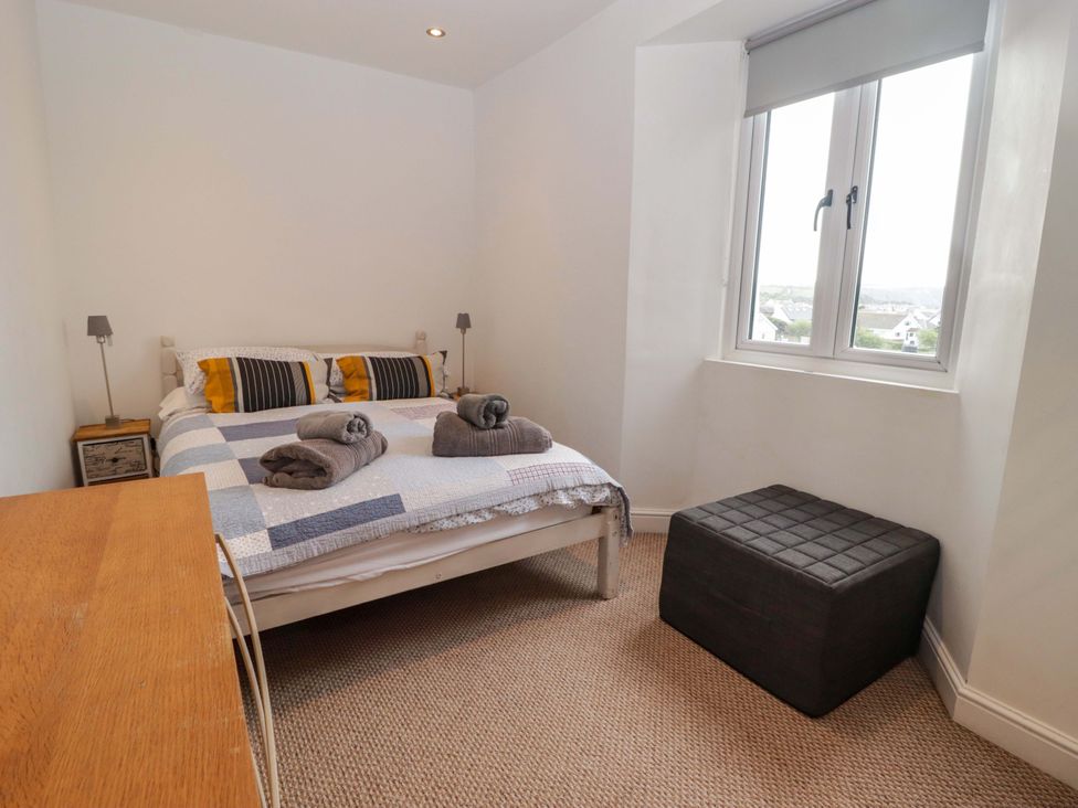 A bedroom with a bed and window at No.8 Millmoor Farm Cottage Broad Haven