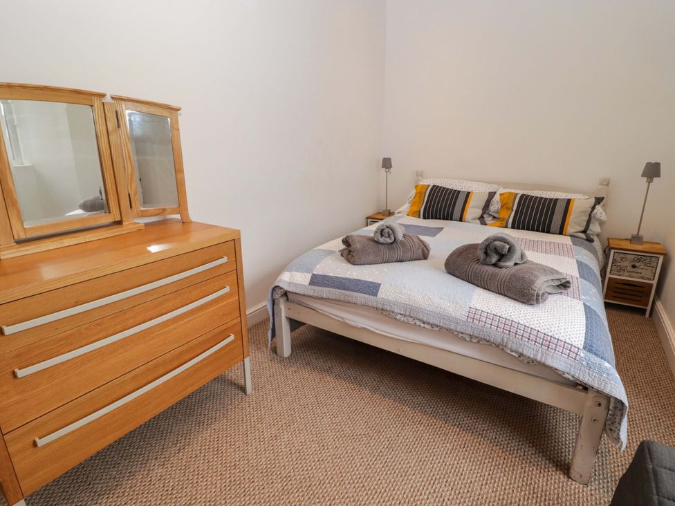 A bedroom with a bed and furniture at No.8 Millmoor Farm Cottage in Broad Haven