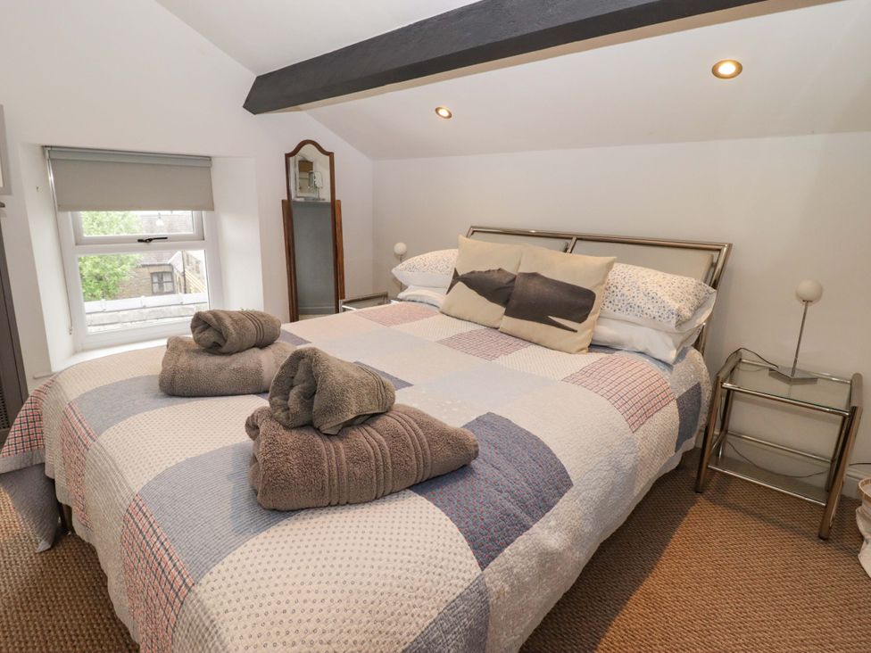 A bedroom with a bed and nightstand at No.8 Millmoor Farm Cottage in Broad Haven