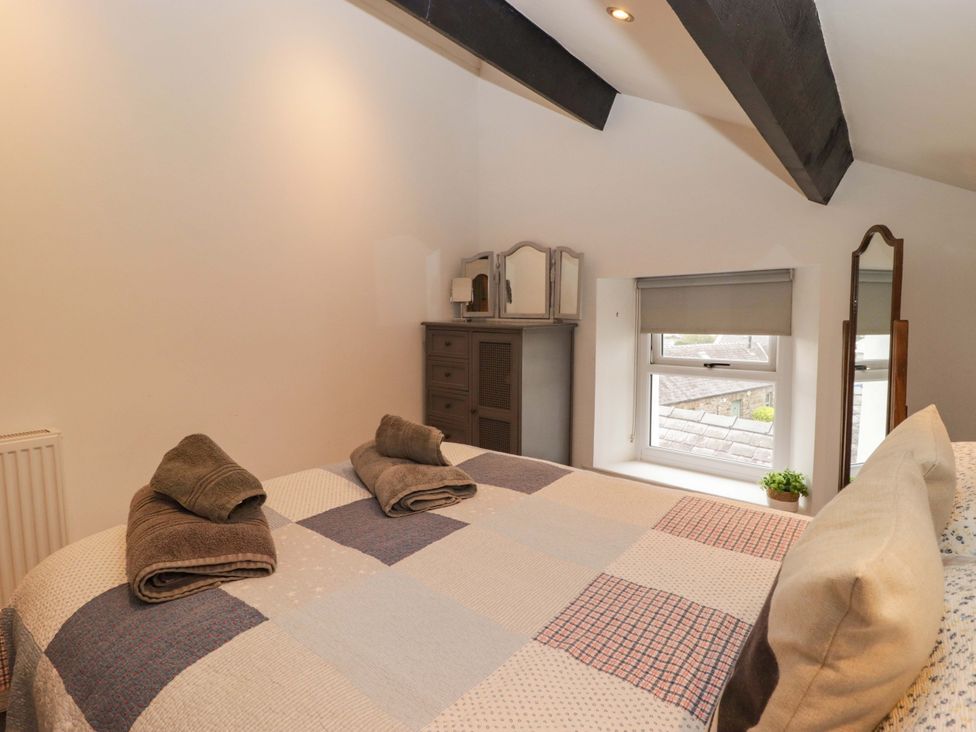 A bedroom with a bed and dresser at No.8 Millmoor Farm Cottage in Broad Haven