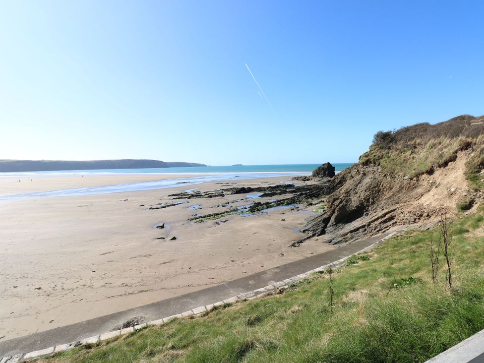 A beach with ocean and cliffs at No.8 Millmoor Farm Cottage in Broad Haven