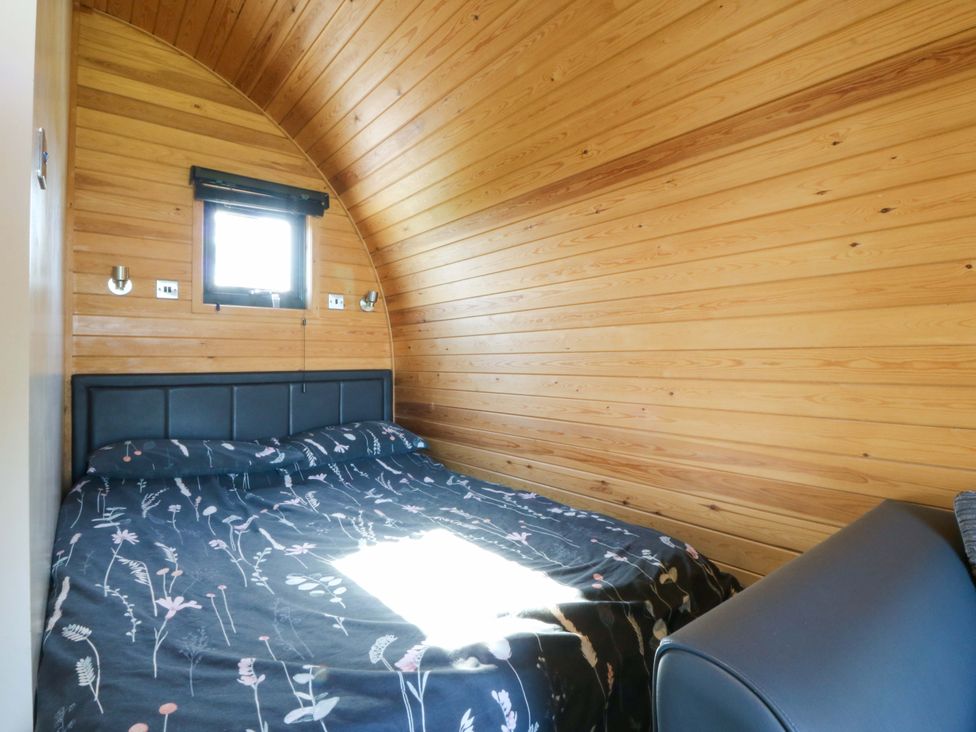 A bedroom with bed and window at Bron Eifion Pod 1 Criccieth