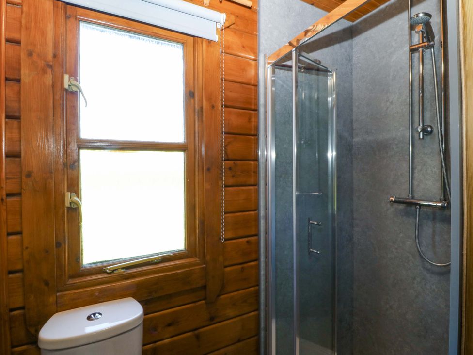 A bathroom with a shower and toilet at Lodge 1 - Bron Eifion, Criccieth