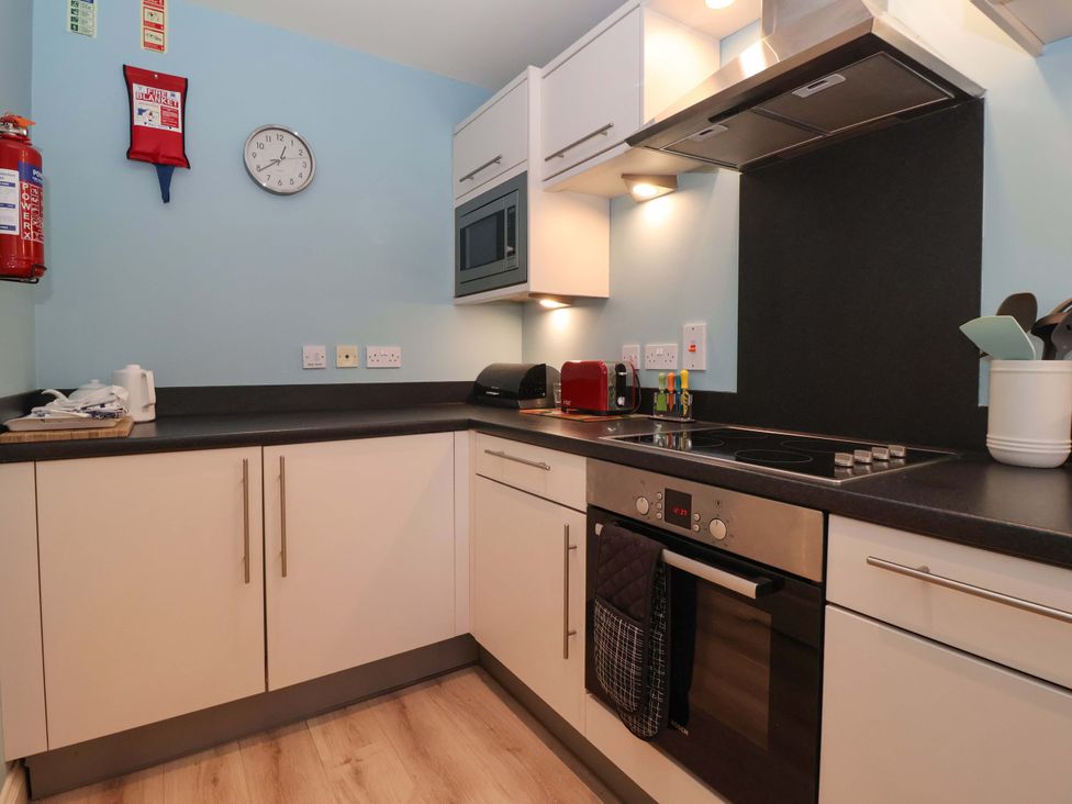 A kitchen with appliances and cabinets at 4 Perran Court in Filey