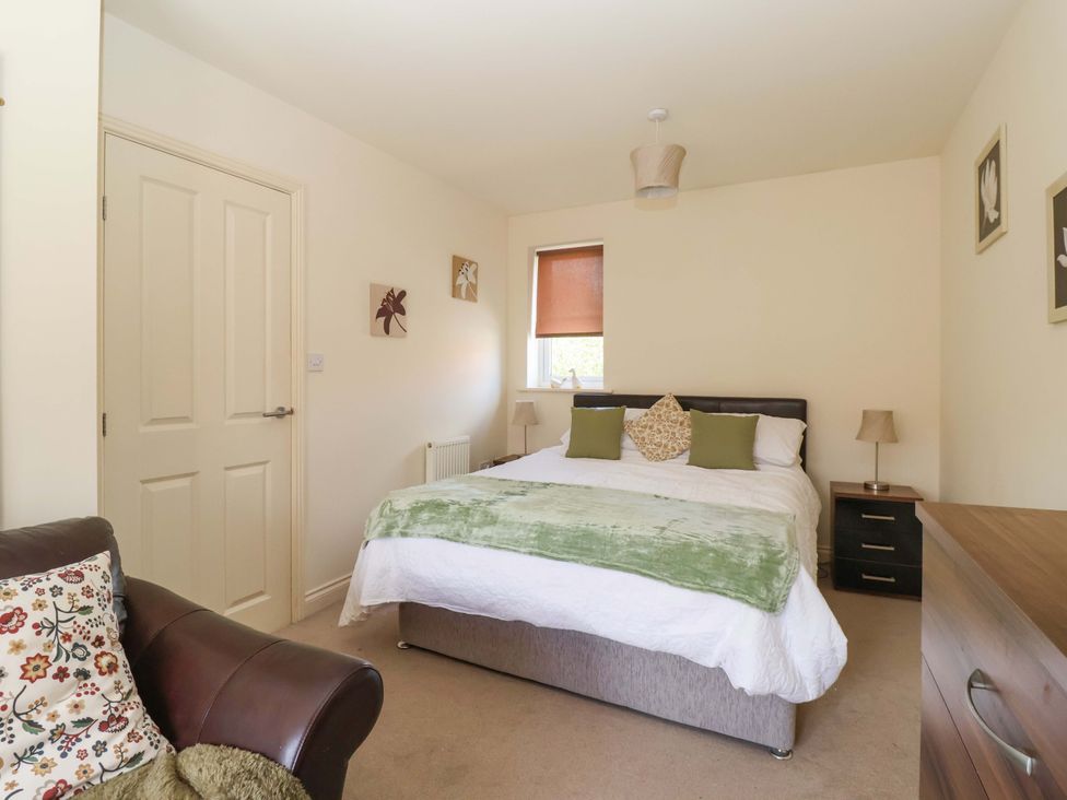 A bedroom with a bed and a bedside table at 4 Perran Court in Filey