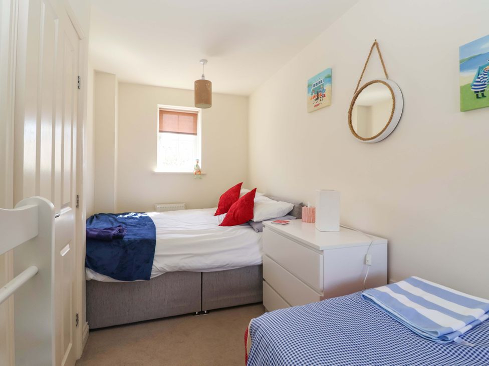 A bedroom with a bed and nightstand at 4 Perran Court in Filey
