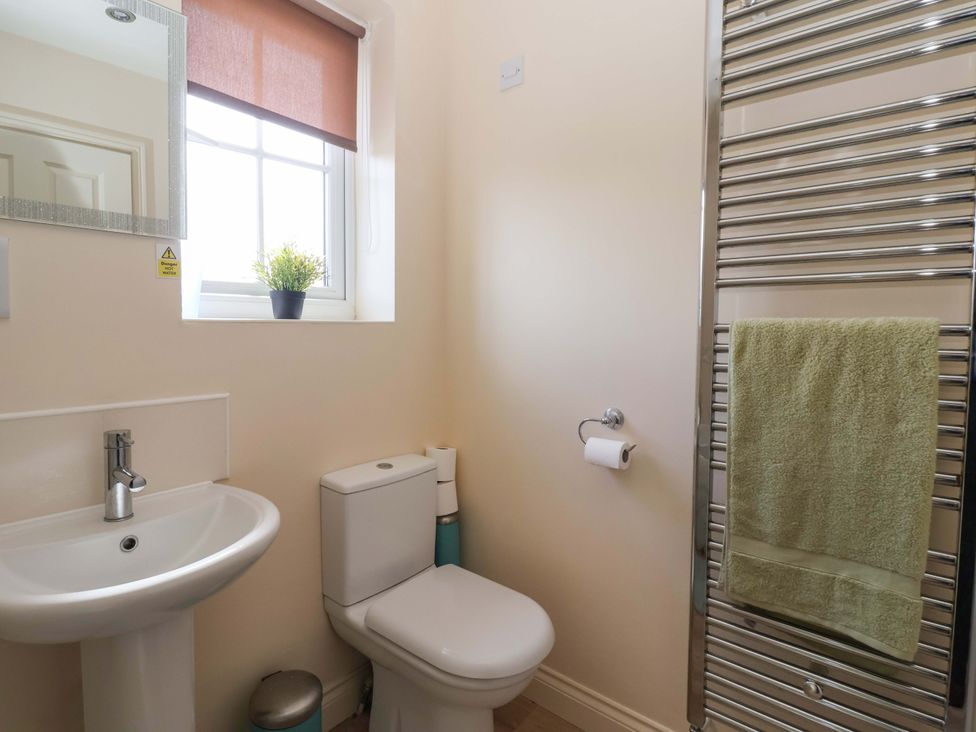 A bathroom with a sink and toilet at 4 Perran Court in Filey