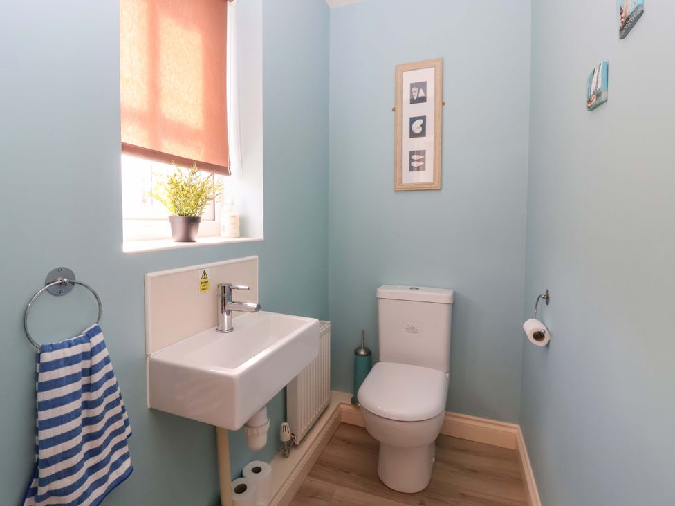 A bathroom with a sink and toilet at 4 Perran Court Filey