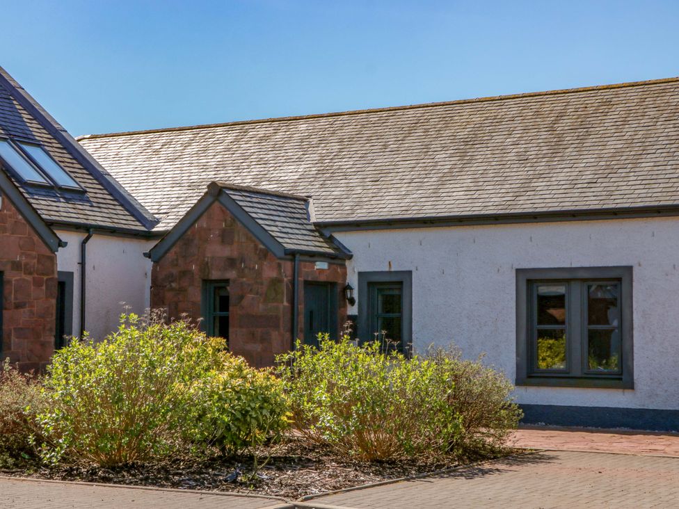An exterior view of a house with plants in the garden at Ballaganlea in Alexandria