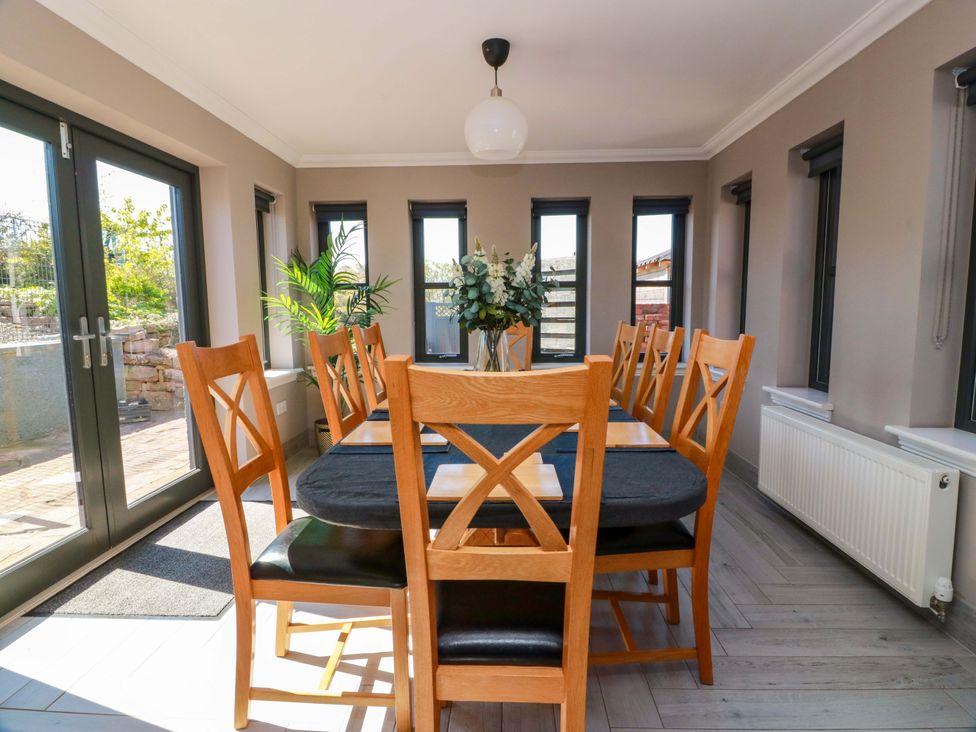 A dining room with a table and chairs at Ballaganlea in Alexandria