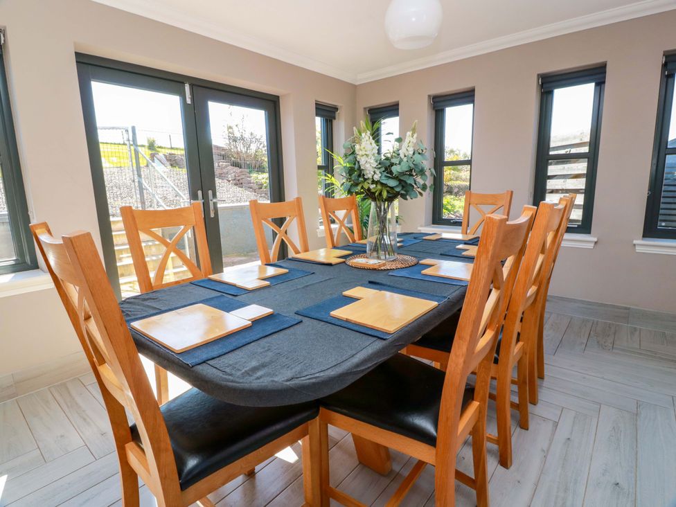A dining room with a table set for meals at Ballaganlea in Alexandria