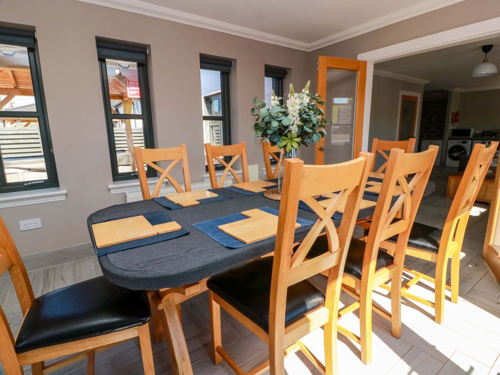 A dining room with a table and eight chairs at Ballaganlea in Alexandria