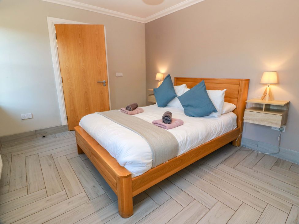 A bedroom with a bed and nightstand at Ballaganlea in Alexandria
