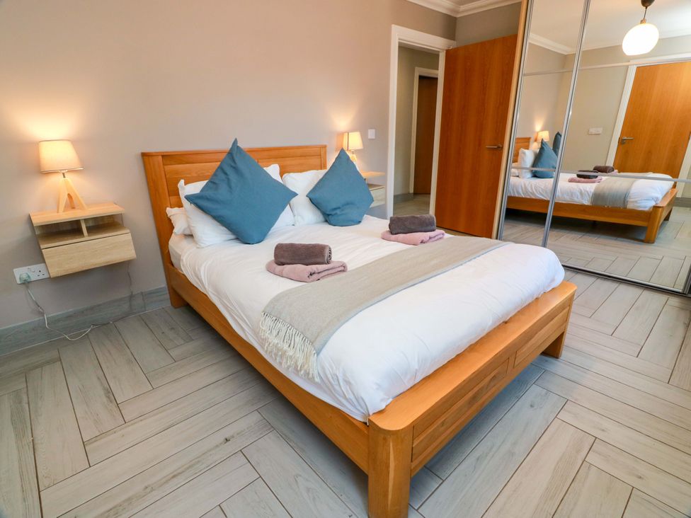 A bedroom with a bed and a bedside table at Ballaganlea in Alexandria