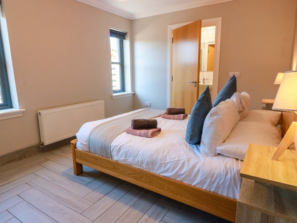 A bedroom with a bed and towels at Ballaganlea in Alexandria