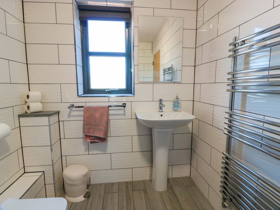 A bathroom with a sink, toilet, and towel rail at Ballaganlea in Alexandria