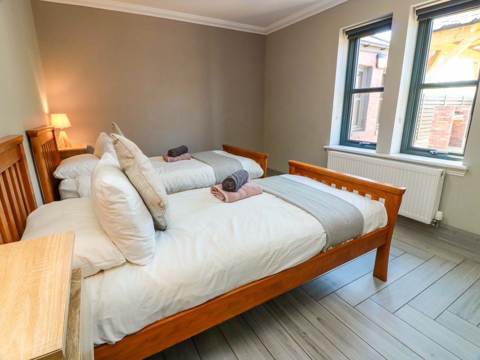 A bedroom with two beds and windows at Ballaganlea in Alexandria