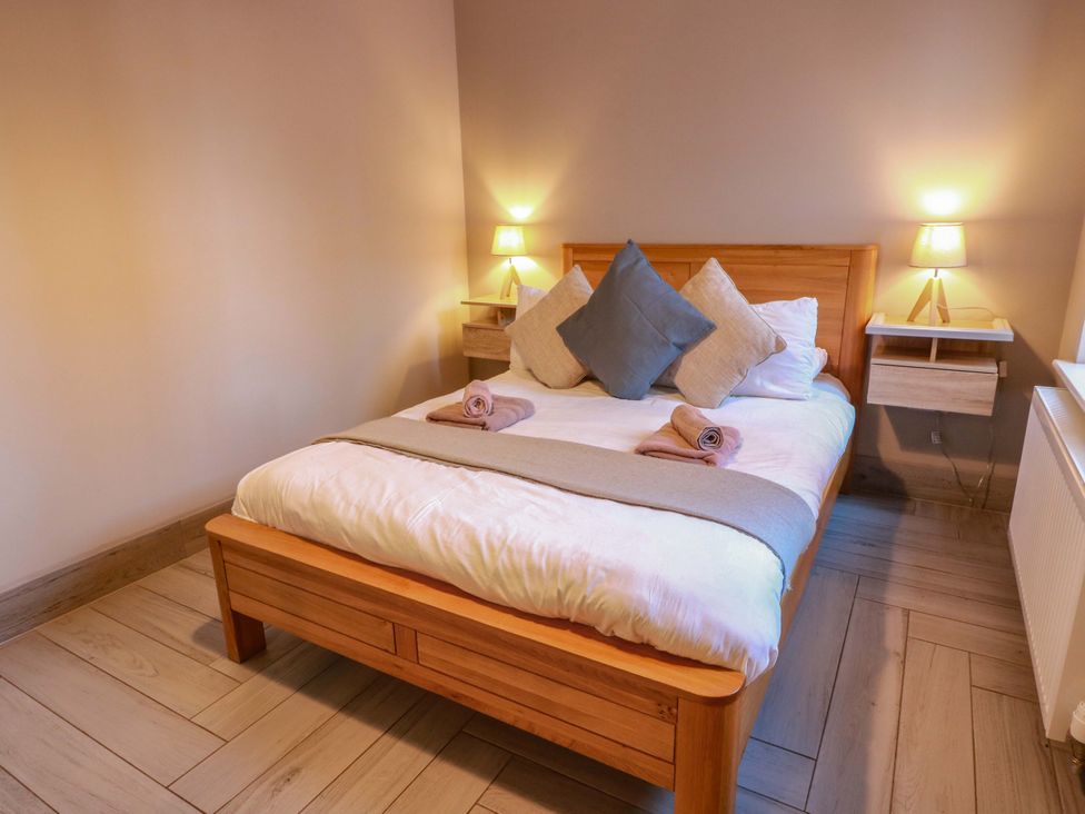 A bedroom with a bed and lamps at Ballaganlea in Alexandria