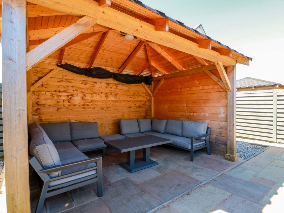 An outdoor lounge area with seating and a table at Ballaganlea in Alexandria