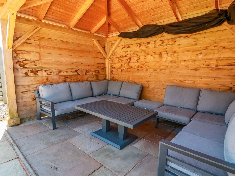 An outdoor seating area with a sofa and coffee table at Ballaganlea in Alexandria