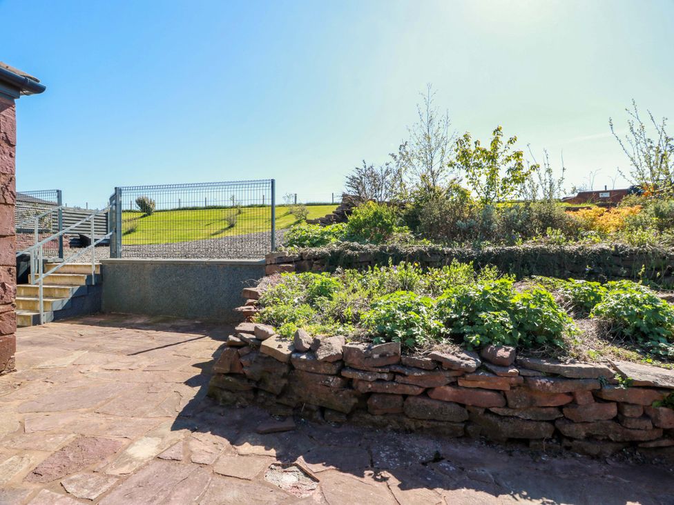 A garden with stairs and a stone wall at Ballaganlea in Alexandria