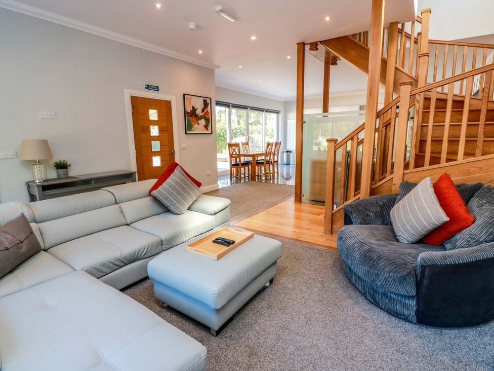 A living room with a sofa and an ottoman at Castle House Lodge in Glasgow