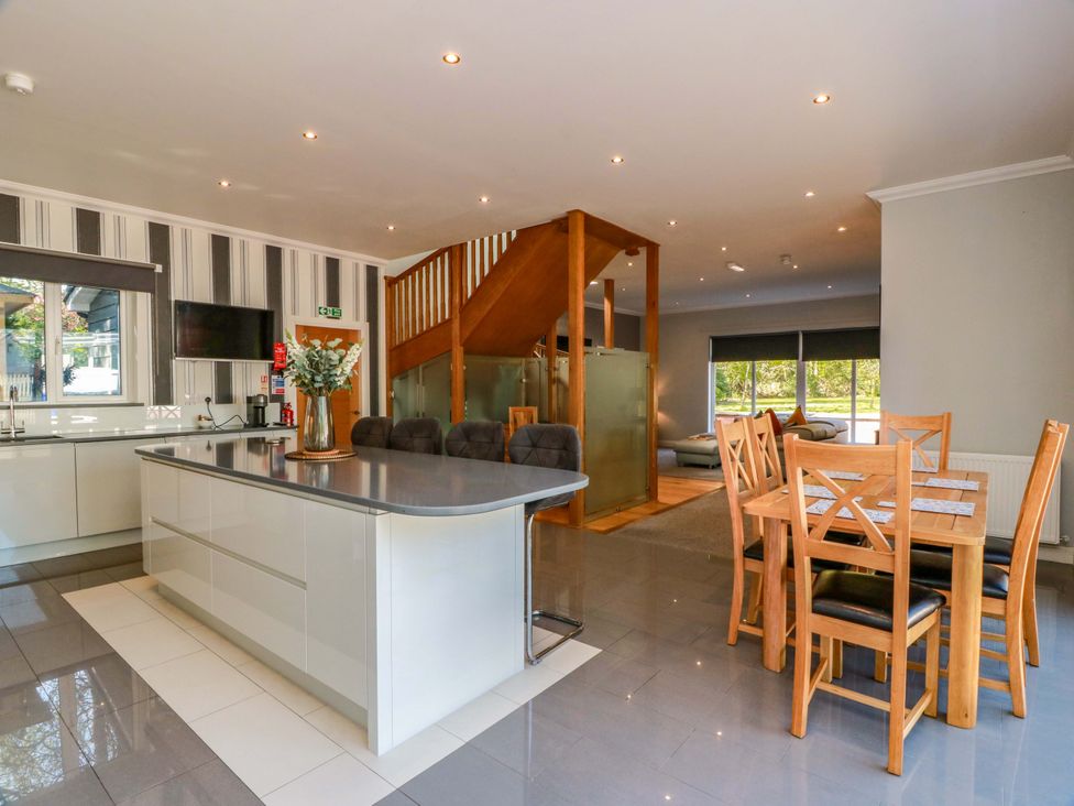 A kitchen with an island and dining area at Castle House Lodge in Glasgow